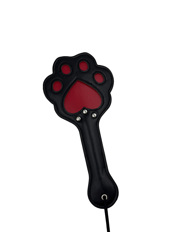 Black leather spanking paddle in the shape of a cat paw with red cutout detailing