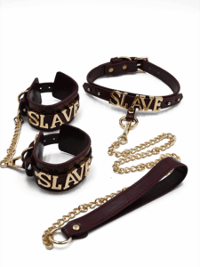 BDSM collar and cuffs set with gold SLAVE lettering and gold chain leash, in burgundy faux leather